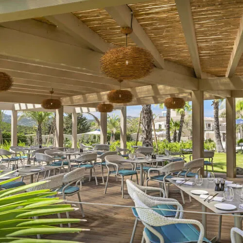 Patio dining area at 7Pines Resort Sardinia, perfect for enjoying award-winning pizzas.